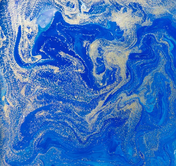 Blue and gold liquid texture. Hand drawn marbling background. Ink marble abstract pattern