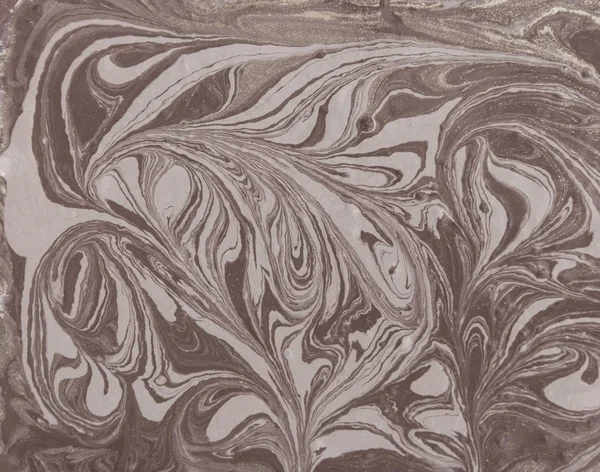 Liquid gold marbled pattern. Beige background