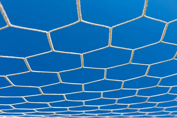 Close up of soccer goal net against clear blue sky — Stock Photo, Image