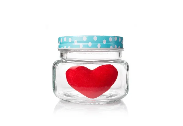 Red felt heart in glass jar with blue poka dot lid — Stock Photo, Image