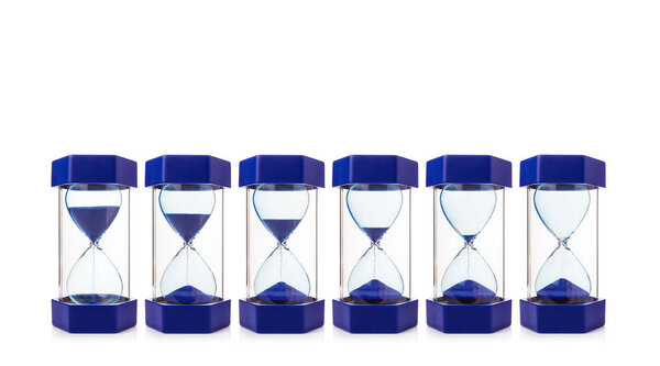 row of six hourglasses showing blue sand dropping from almost fu