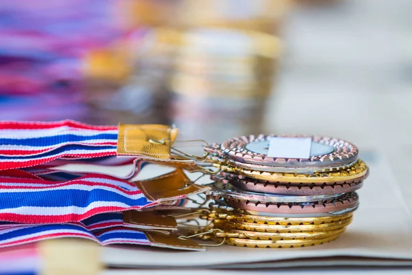 stacks of gold, silver, and bronze medals