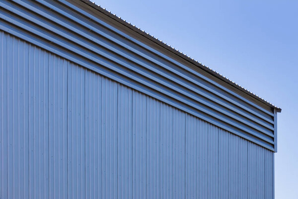 Metal sheet wall panels and roofs against clear blue sky, demonstrating the usage of metal sheet construction material