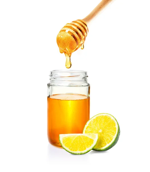Miel en frasco de vidrio con tarro de miel de madera y lima cortada en whit — Foto de Stock