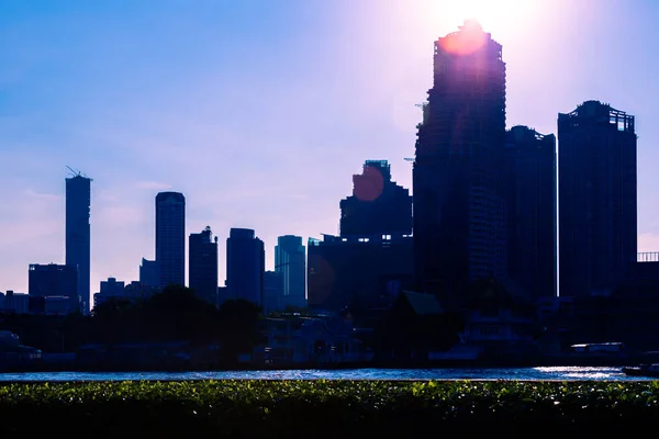 Bangkok morning sky, sun rising above high rise buildings near t