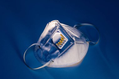 Beyaz masada N95 maskesi dramatik zıt aydınlatma, sağlık konsepti