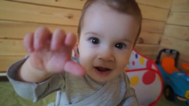 The child reaches for the camera. — Stock Video