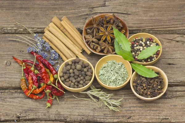 Variety of spices on wooden background — Stock Photo, Image