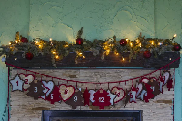 Advent calendar hanging on fireplace — Stock Photo, Image