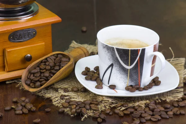 Чашка кофе, кофейные зерна и старая кофемолка — стоковое фото