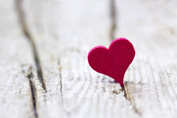 red heart on wooden background