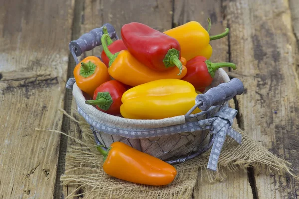 Colorful peppers in a basket Stock Picture