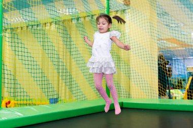 Bir trambolin üzerinde atlama doğum günü eğlence kız. Neşeli ve tasasız çocukluk.