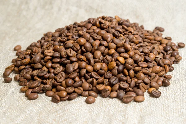 Spilled grains of fragrant coffee close-up. — Stock Photo, Image