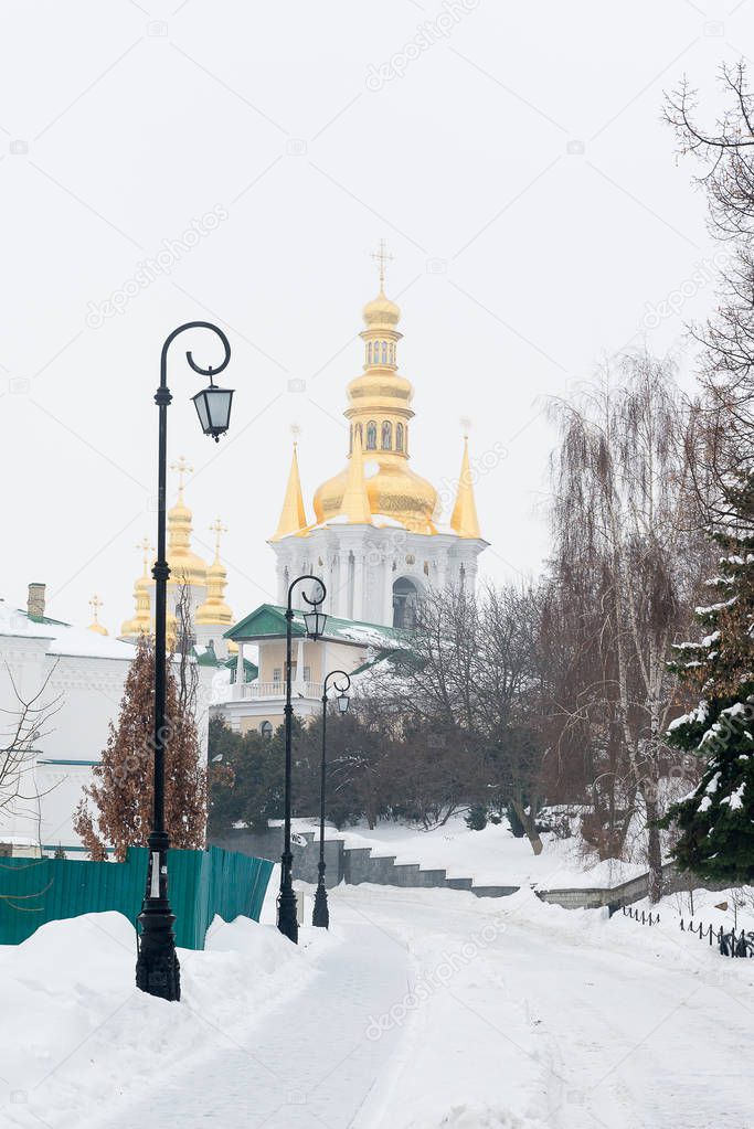 Kiev, Ukraine. Pechersk Lavra Monastery. A snow-covered avenue leading to distant caves.