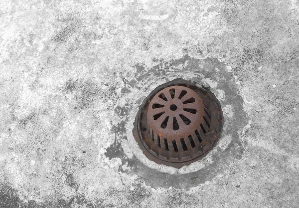 Old sewer grate drain water