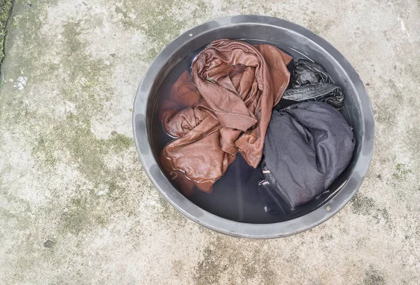 Moczyć brudne ubrania w dorzeczu czarny dla oczyścić z bliska — Zdjęcie stockowe