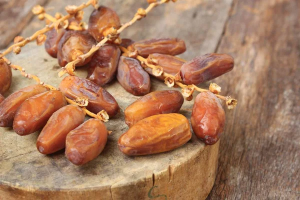 Dried date palm. fruit  Delicious fresh organic date palm  on  wooden floor