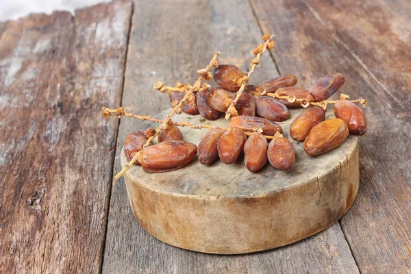 Dried date palm. fruit  Delicious fresh organic date palm on  wooden