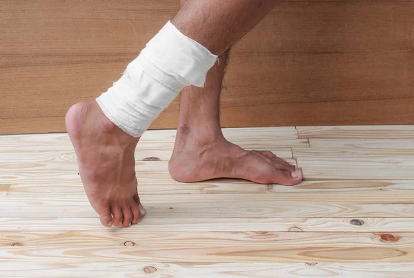 Gauze bandage of physician the treating case with ankle Injured — Stock Photo, Image