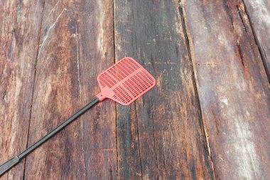 Red fly swatter. Single flyswatter made of plastic and unfailing clipart