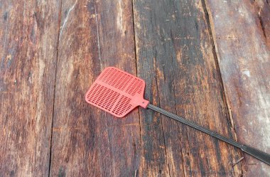 Red fly swatter. Single flyswatter made of plastic and unfailing clipart