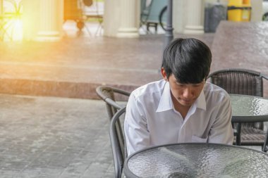 Genç adam yakışıklı bend kafede bekleyen baş aşağı oturuyor 