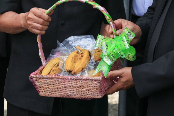 Hand of  giving banana basket gift for health in day Christmas and New Year