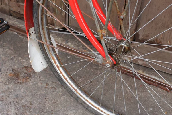 Roda vintage para bicicleta velho estilo enferrujado na parede fundo de madeira — Fotografia de Stock