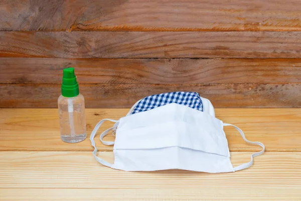 mask fabric striped blue - white homemade and Hand wash gel on table. prevent coronavirus or (Covid-2019) concept prophylaxis