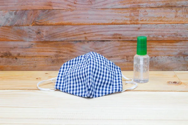 mask fabric striped blue - white homemade and Hand wash gel on table. prevent coronavirus or (Covid-2019) concept prophylaxis