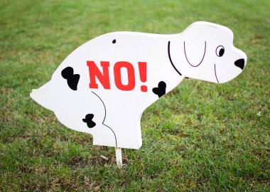 Sign on the lawn prohibiting dog walking clipart
