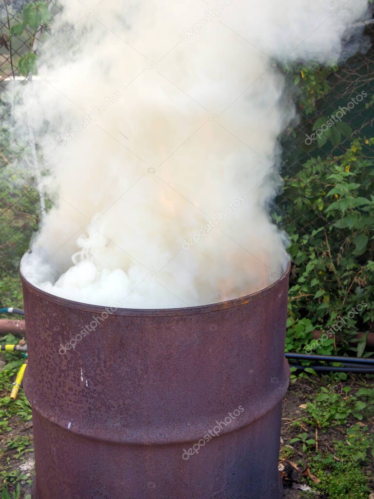 An old barrel is used as a waste incinerator