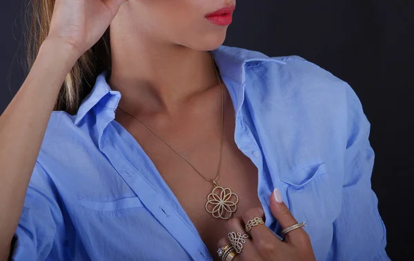 Silver jewelery on woman hand on a black background — Stock Photo, Image