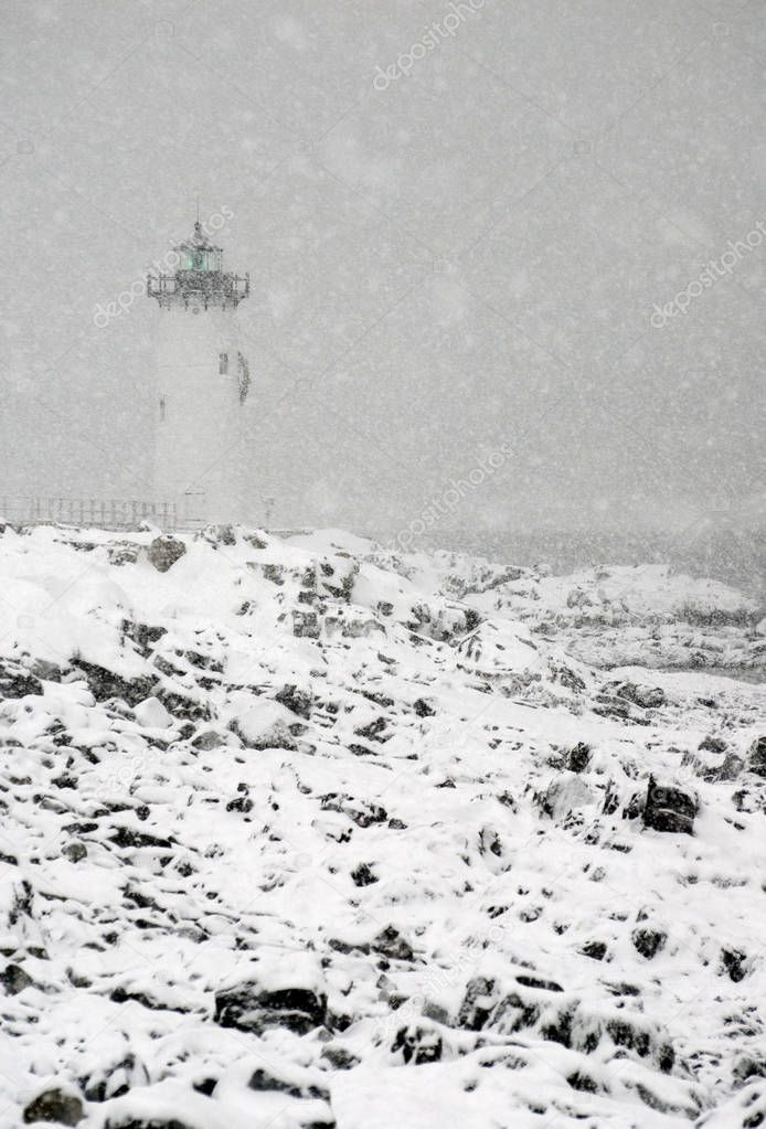 New England Lighthouse Flashes green During Snowstorm