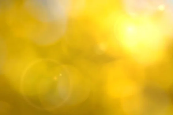 Fondo bokeh amarillo con efecto de destello de lente — Foto de Stock