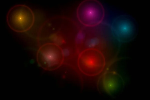 Abstract black background with multi color light flares — Stock Photo, Image