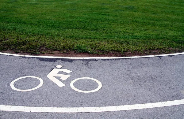 White traffic sign, bicycle lane symbol on curve asphalt road