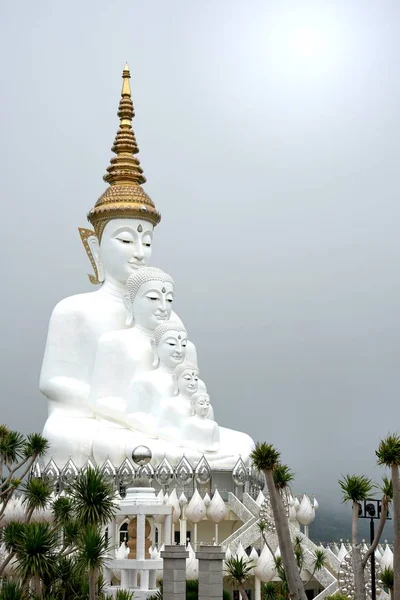 Big five white Buddha statue on cloudy sky background at Wat Pha