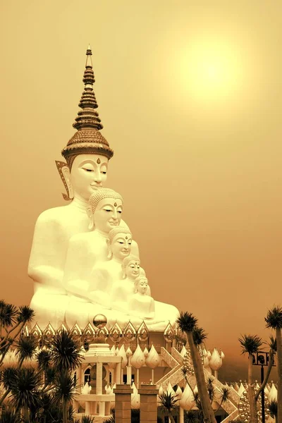 Big five white Buddha statue with the sun light on cloudy sky ba