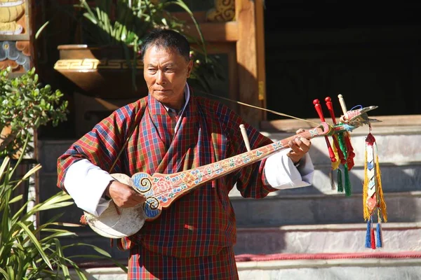 PARO, BHUTAN - 10 de noviembre de 2012: Anciano músico no identificado — Foto de Stock