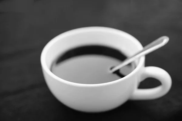 White cup of black coffee on black background in black and white — Stock Photo, Image