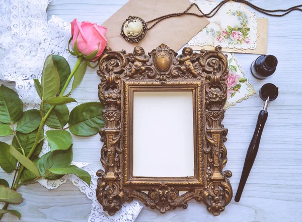 Vintage mockup. Vintage frame with little angels, pink rose, lace, pearls, ink and pen, old postcards