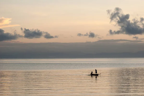 Silhouette of fishermen at sunrise.