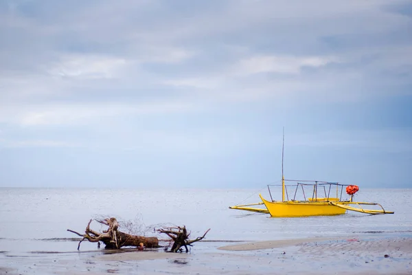 Yellow boat anchored at the shore