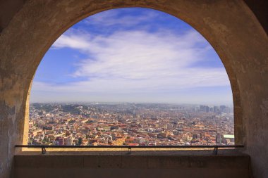 Panoramic view of the city of Naples through the arch of the medieval fortress Castel Sant'Elmo. Skyline with historical Old town, Spaccanapoli street and modern financial district skyscrapers, Italy. clipart