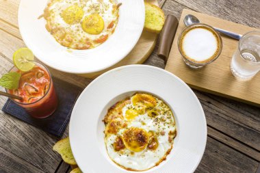 Kızarmış yumurta masada cappuccino kahve servis ve kahvaltıda meyve suyu karışımı