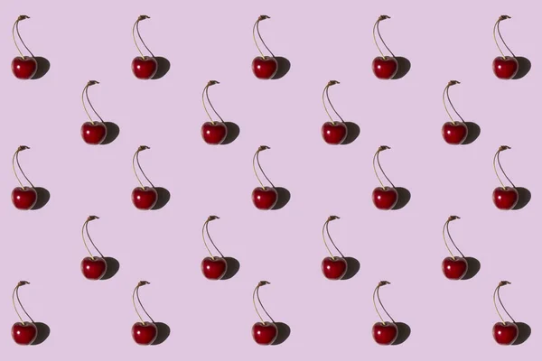 Yumuşak pembe arka planda izole edilmiş kiraz deseni. Taze. Doğa.