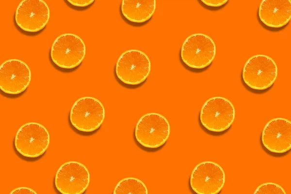 Half cut oranges pattern isolated on orange background. Fresh. Nature.