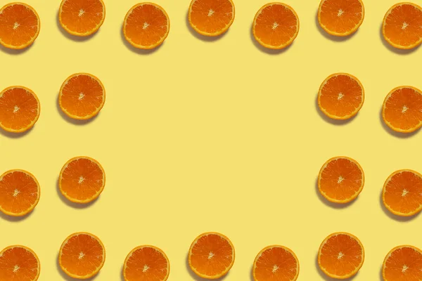 Half cut oranges pattern isolated on yellow background. Fresh. Nature.